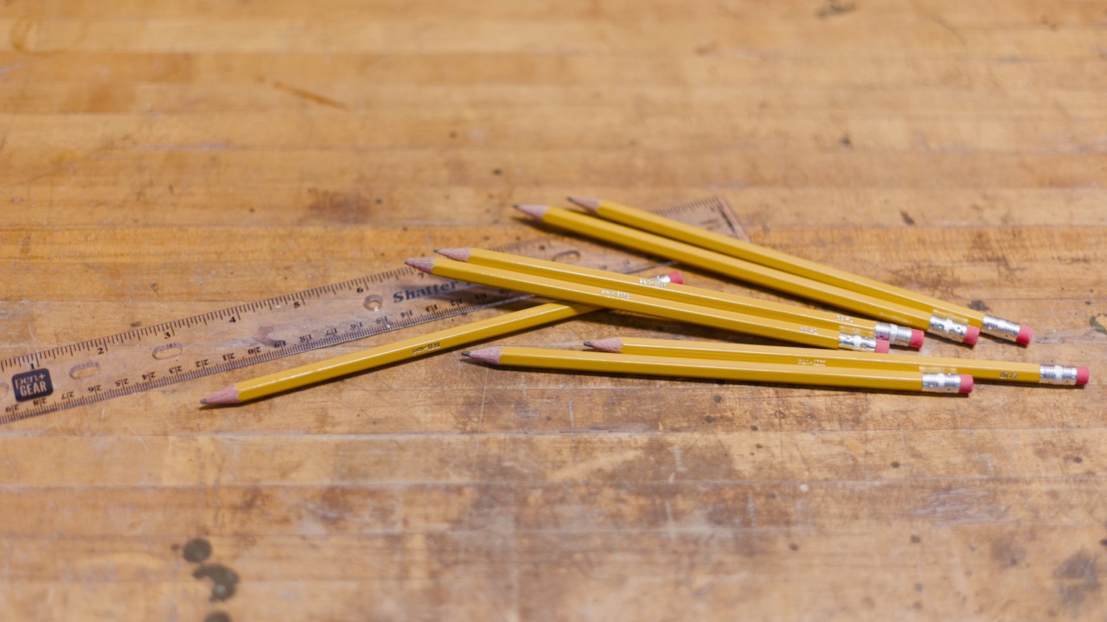 Yellow pencils and a clear ruler on a workbench