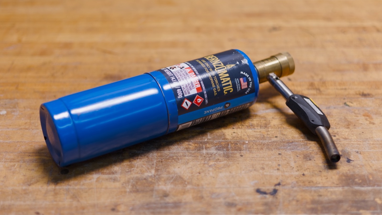 A Bernzomatic propane torch on a workbench