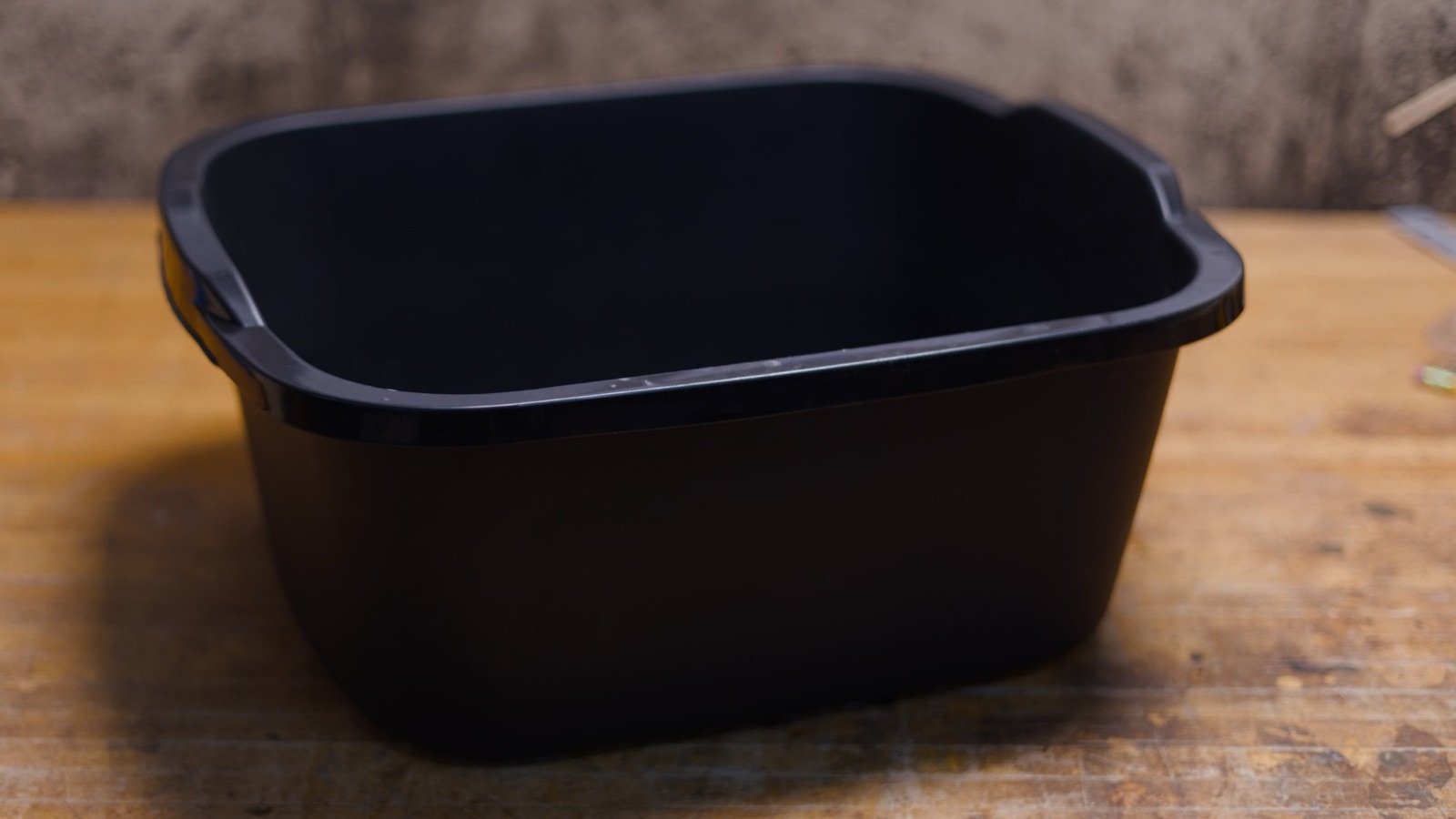 A black plastic tub for soaking reed